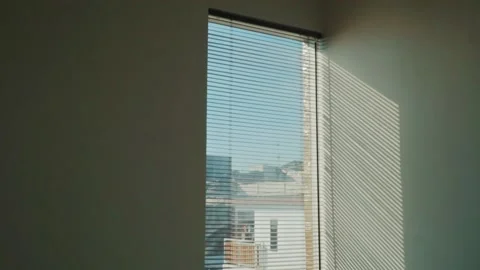 Rays of setting sun through the roller blinds on window, Sunshine over the Video stock 148453251