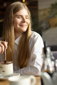 The rays of the spring sun illuminate the face of a beautiful girl. Stock Photos