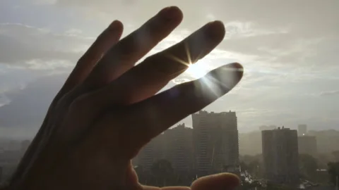 Rays of the Summer SunShine on Lens. Man Hand Covers Sun. Close-up of Human Hand Stock Footage 134332733
