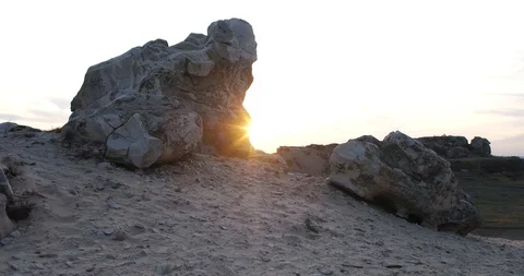 Rays of the sun among the stones of a mountain peak at sunset 動画素材 122383047