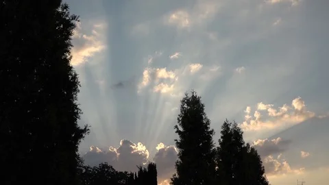 Rays of the sun from behind the clouds. Camera hitting Stock Footage 100289249