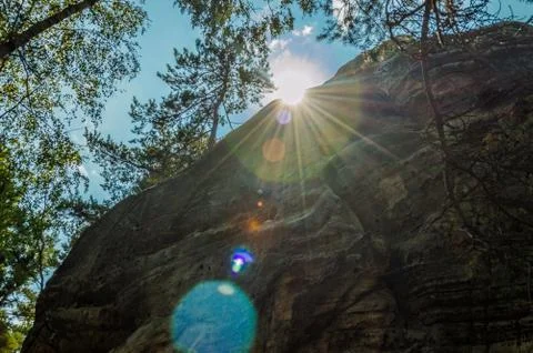 Rays of the sun from behind the rocks Stock Photos