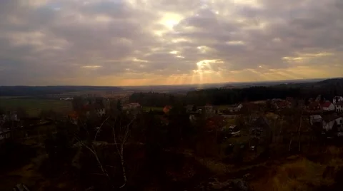Rays of the sun between the clouds flying the village Stock Footage 48422635