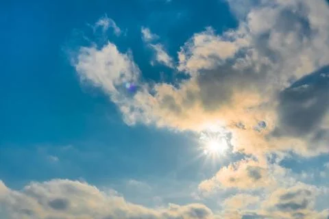 The rays of the sun break through the clouds.Blue sky with white feather clou Stock Photos