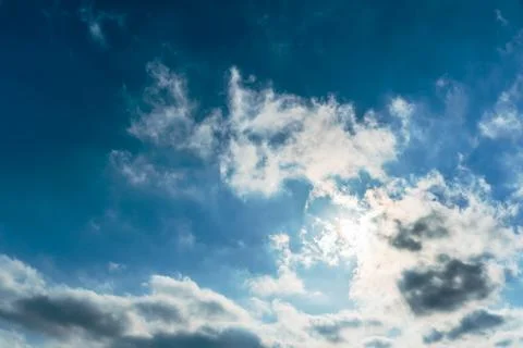 The rays of the sun break through the clouds.Blue sky with white feather clou Stock Photos