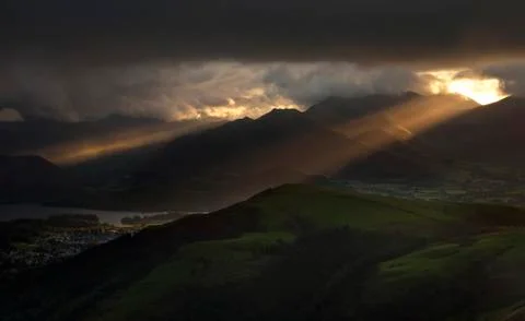 Rays of the sun break through gloomy clouds Stock Photos