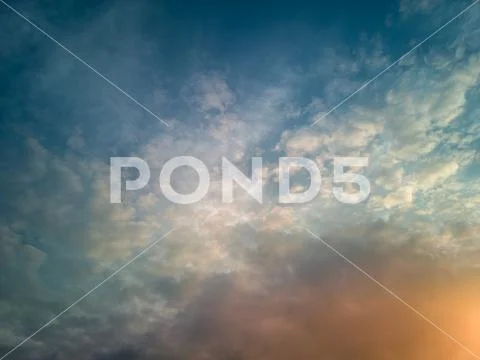 The rays of the sun breaking through the dramatic clouds in the evening or .. Stock Photos