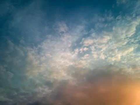 The rays of the sun breaking through the dramatic clouds in the evening or .. Stock Photos