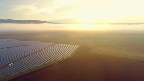 The rays of the sun at dawn illuminate the beautiful valley in which the solar Stock Footage 156462398
