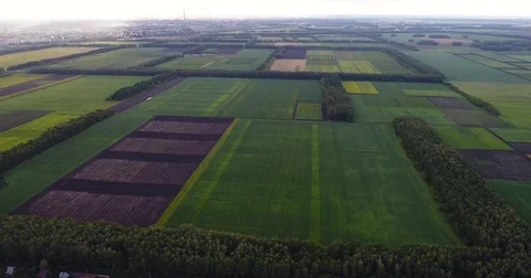 The rays of the sun fall on the city with the factory pipes. Nearby it's raining Stock Footage 78588363