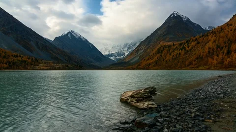The rays of the sun make their way through the snowy clouds at Lake Akkem. Stock Footage 70619034