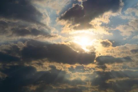 The rays of the sun make their way through dramatic thunderclouds Stock Photos
