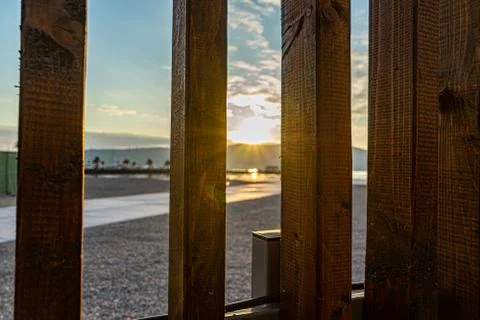 Rays of the sun make their way through a wooden fence. Foto stock
