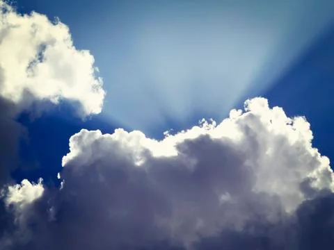 Rays of the sun makes his way from behind the clouds Stock Photos