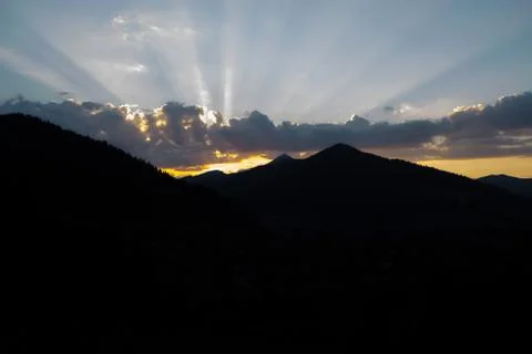 Rays of the sun making their way through the clouds against the backdrop of t 写真素材