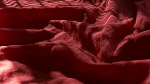 The rays of the sun move on the red cloth, time-lapse. Video stock 209319051