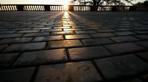Rays of sun over parapet on tile sidewalk Stock Footage 11365353