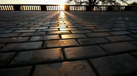 Rays of sun over parapet on tile sidewalk Stock Footage 11365433