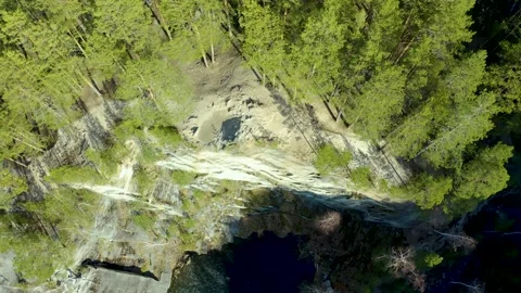Rays of the sun piercing the forest and falling on the water of flooded quarry Stock Footage 165317706