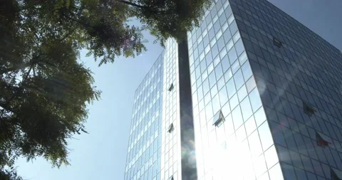 Rays of the sun reflected in an office skyscrape Stock Footage 131364975