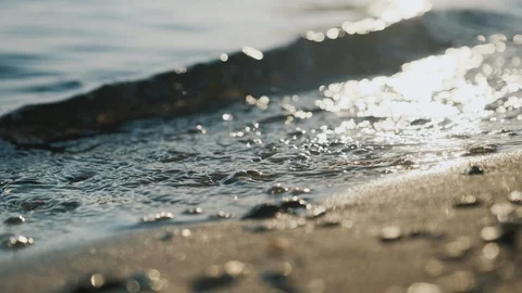 The rays of the sun, sea waves on the shore close-up. Dawn sunrise sunset at sea Stock Footage 119908180