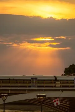 Rays of sun shining through clouds onto a train Stock Photos