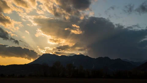 Rays of the sun at sunset from behind the mountain timelapse Stock Footage 134575988