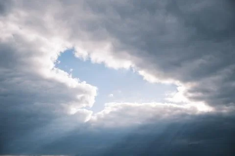 Rays of sun through the clouds Stock Photos
