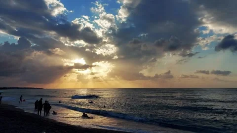 Rays of sun through clouds in the sky against the background of the sea and Stock Footage 304110888