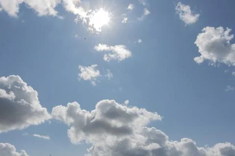 Rays of the sun through the clouds in the sky Stock Photos