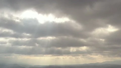 Rays of sun through the cloudy sky 4K drone footage Stock Footage 105400113
