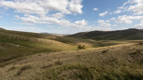 Rays of sunlight break through the clouds and cast sunspots and plays of ligh Stock Photos