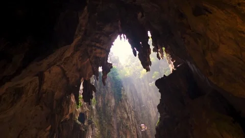 Rays of sunlight entering Batu Caves at Kuala Lumpur, Malaysia. Ancient limeston Stock Footage 340190196