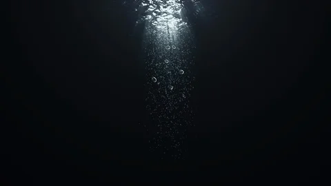 Rays of Sunlight Penetrate Clear Water, Air Bubbles Rise to the Surface. Stock Footage 116993695