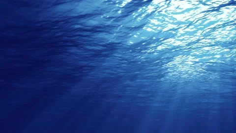 Rays of sunlight shining from above, penetrating deep clear blue water Video stock 104704476