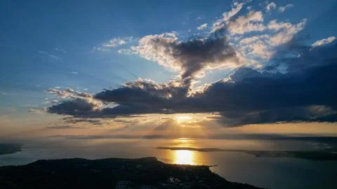 Rays of sunlight through thick clouds illuminate the surface of the sea, footage Stock Photos