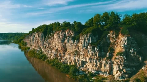The rays of the sunset illuminate the protrusions of the high mountain. Green Stock Footage 156981673