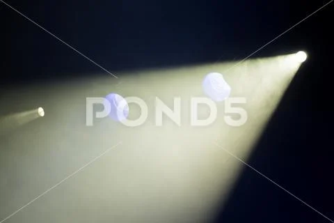 Rays theatrical spotlights on the stage during the performance Stock Photos