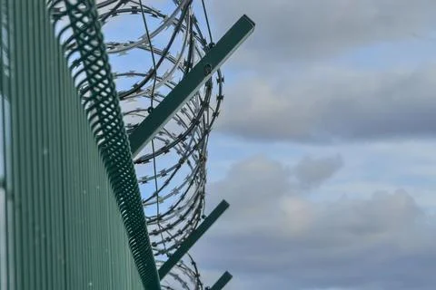 Razor barbed wire on a high security building. Razor wire and heavy-proof wire Stock-Fotos