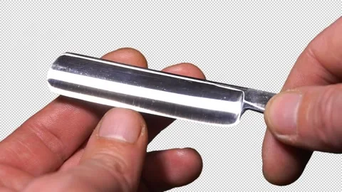 Razor in hand - Alpha channel. Stock Footage 138383613