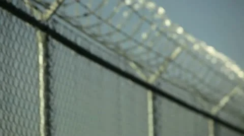 Razor wire and chain link fencing Stock Footage 20543750