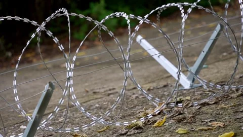 Razor Wire Loops and Support Brackets from Ground Level Stock-Footage 344120632