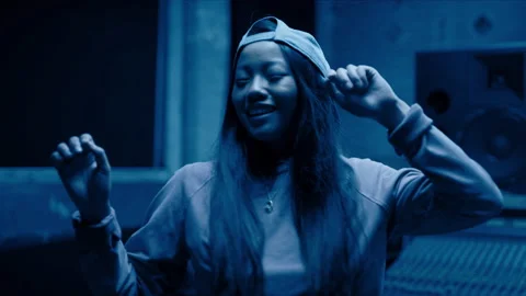 R&amp;B dancer grooving and dancing in her music studio in dark blue light. Hand dra Stock Footage 199455194