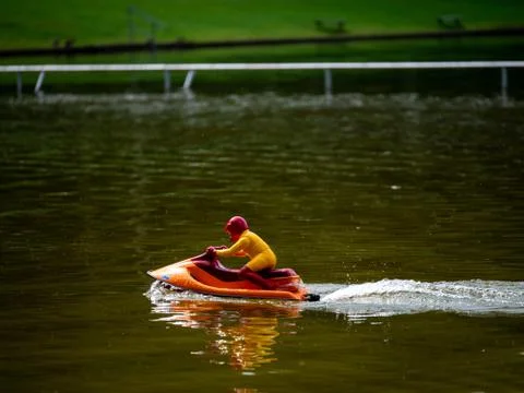RC controlled jet ski model on lake. Active summer vacation for school child. Stock Photos