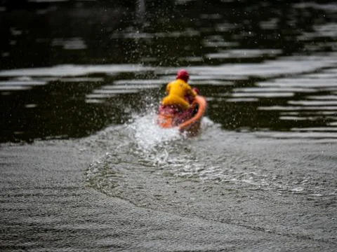 RC controlled jet ski model on lake. Active summer vacation for school child. Stock Photos