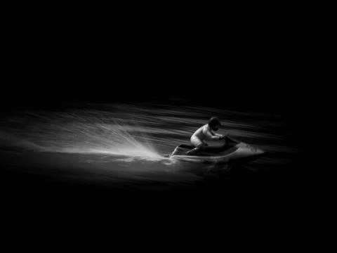 RC controlled jet ski model on lake on black background. Stock Photos