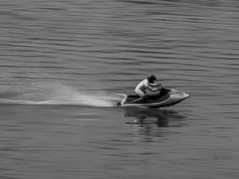RC controlled jet ski model on lake black and white. Stock Photos