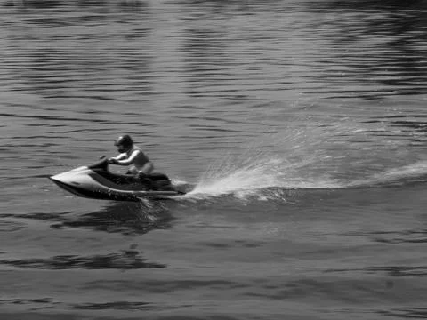 RC controlled jet ski model on lake black and white. Stock Photos