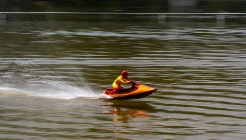 RC controlled jet ski model on lake. Stock Photos