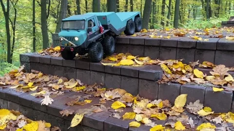 RC flatbed towing truck going downstairs in the park. Stock Footage 207405819